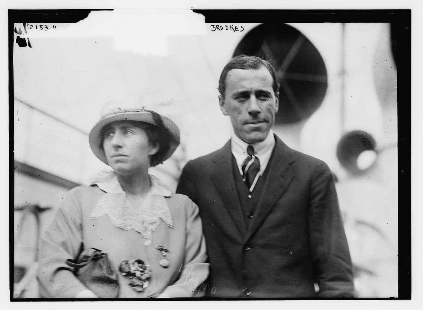 Norman Brookes in a suit standing beside his wife in an early twentieth century photograph