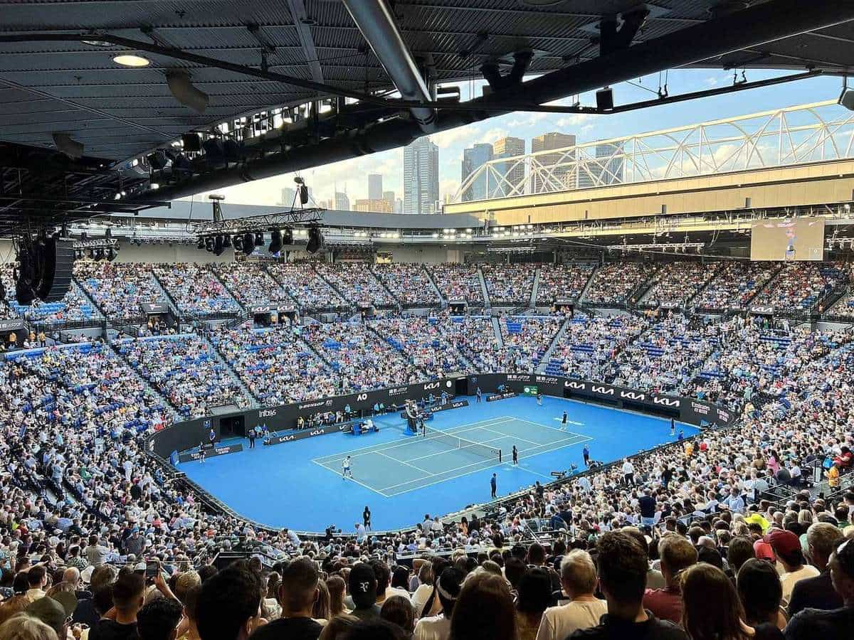 Rod Laver Arena packed with spectators around a blue hard court during an Australian Open match